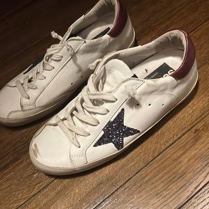 Golden goose sneakers with blue sequence star.